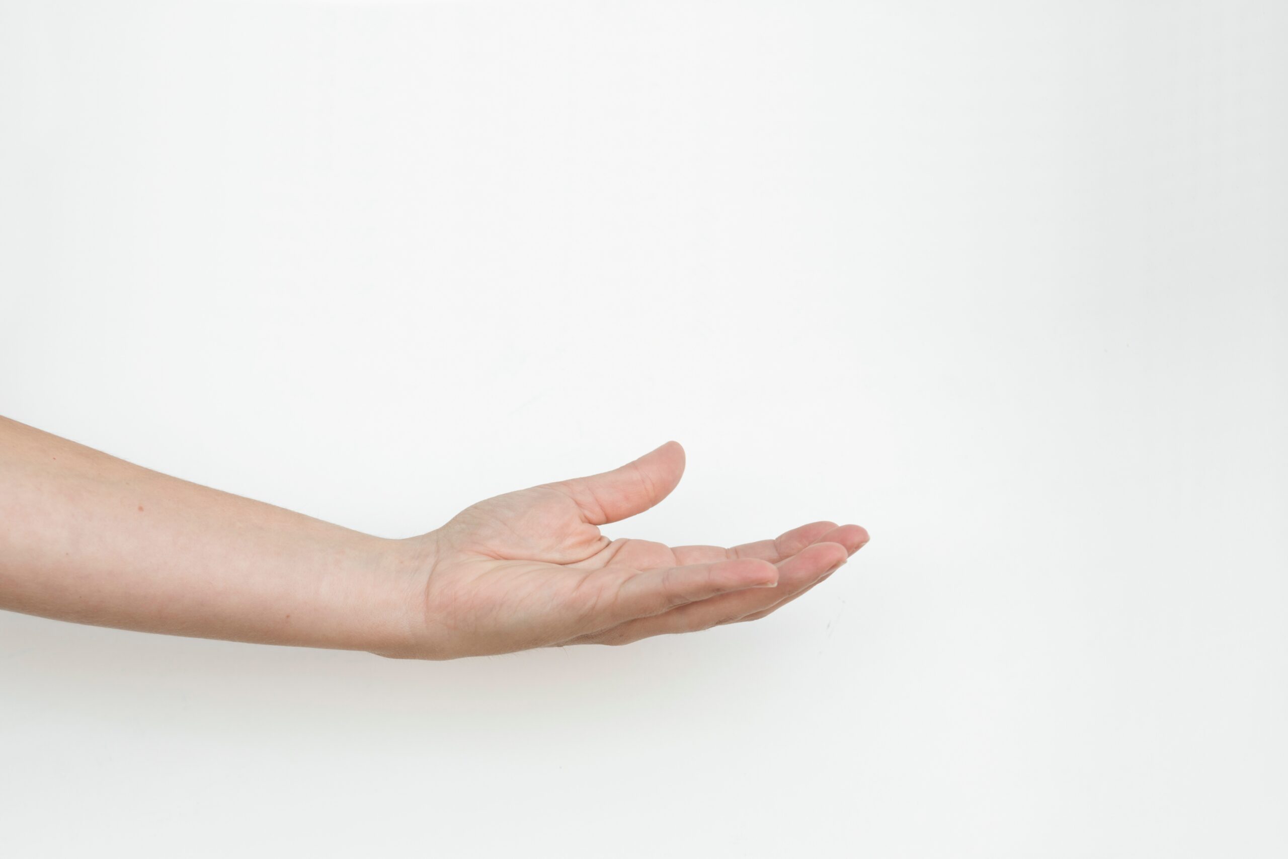 persons hand on white surface